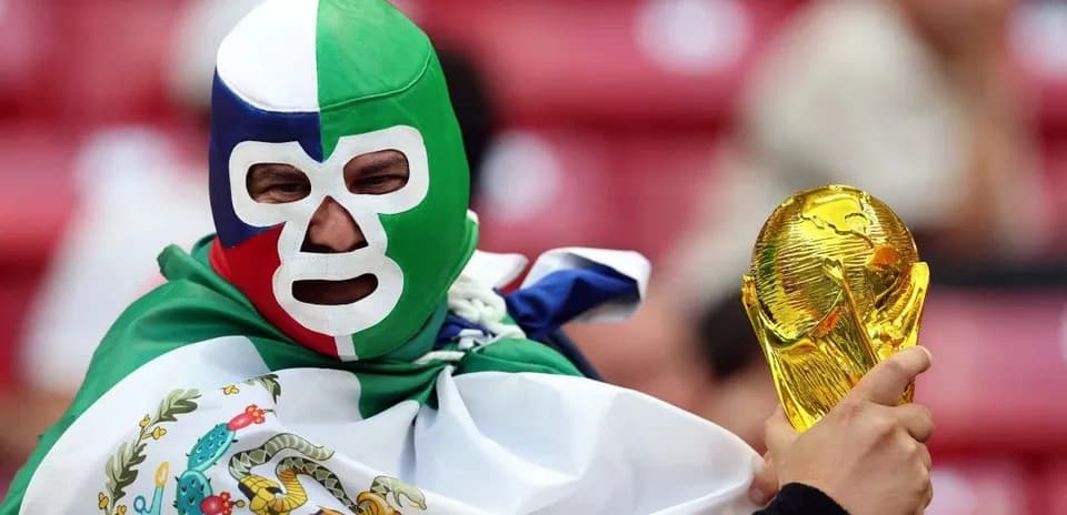 A fan wearing a mask holding a trophy