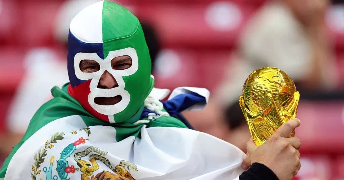 A fan wearing a mask holding a trophy