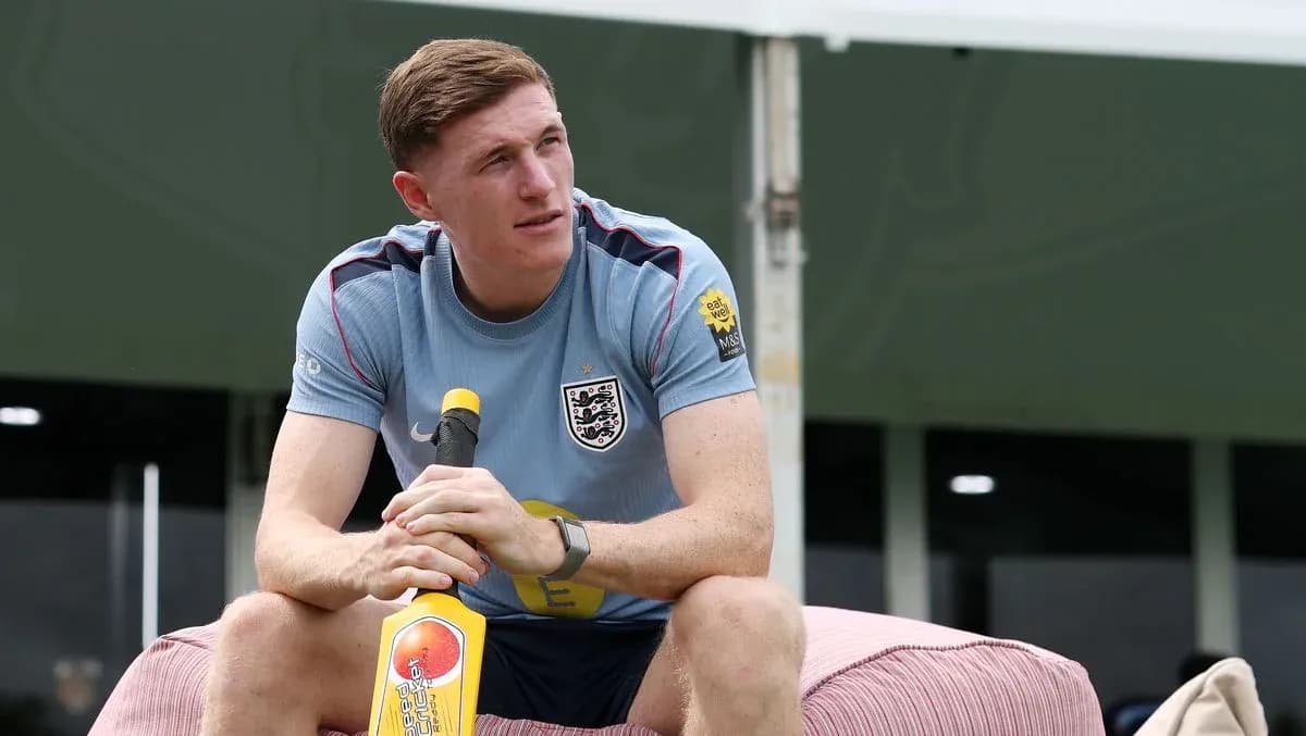 Jugador sentado con un bate de cricket en entrenamiento