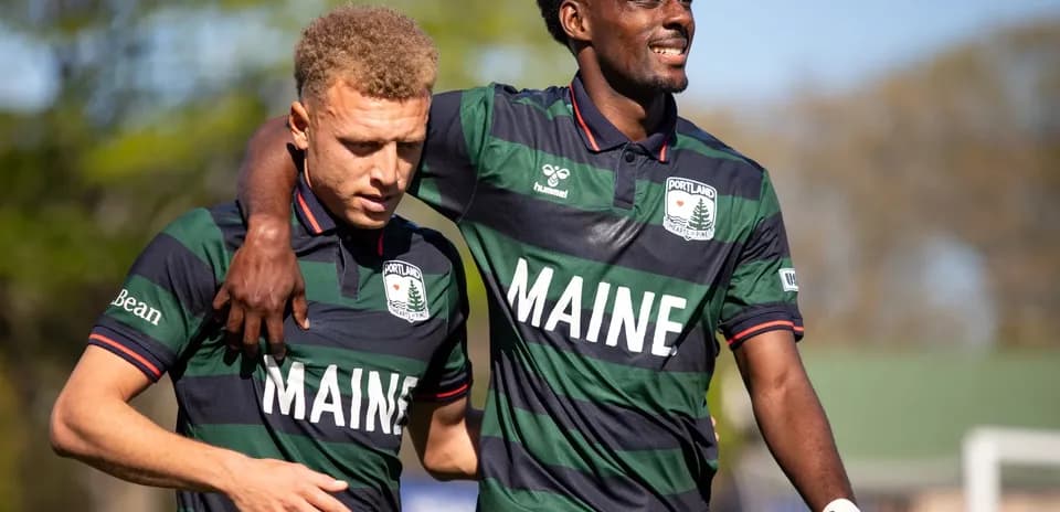 Dos jugadores de Portland Hearts of Pine abrazándose