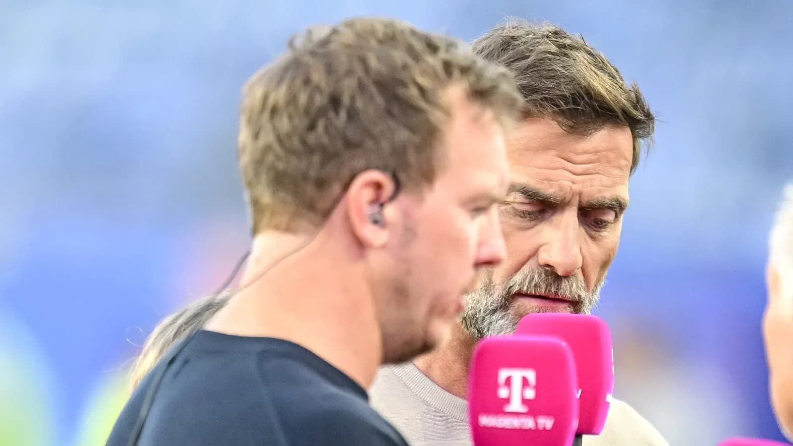 Dos hombres conversando en una entrevista deportiva