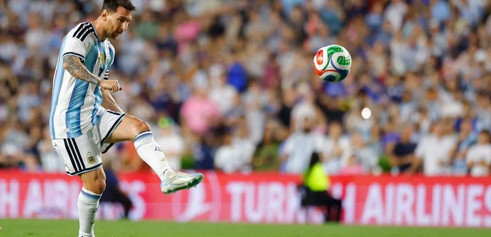 Lionel Messi preparing to kick the ball during match
