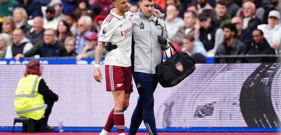Jugador de Arsenal siendo ayudado por el personal médico