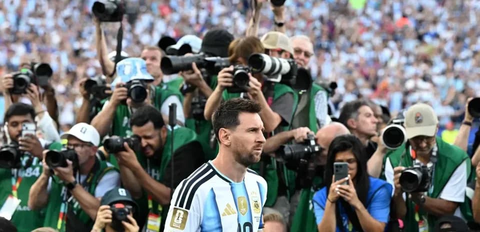 Lionel Messi surrounded by photographers after match