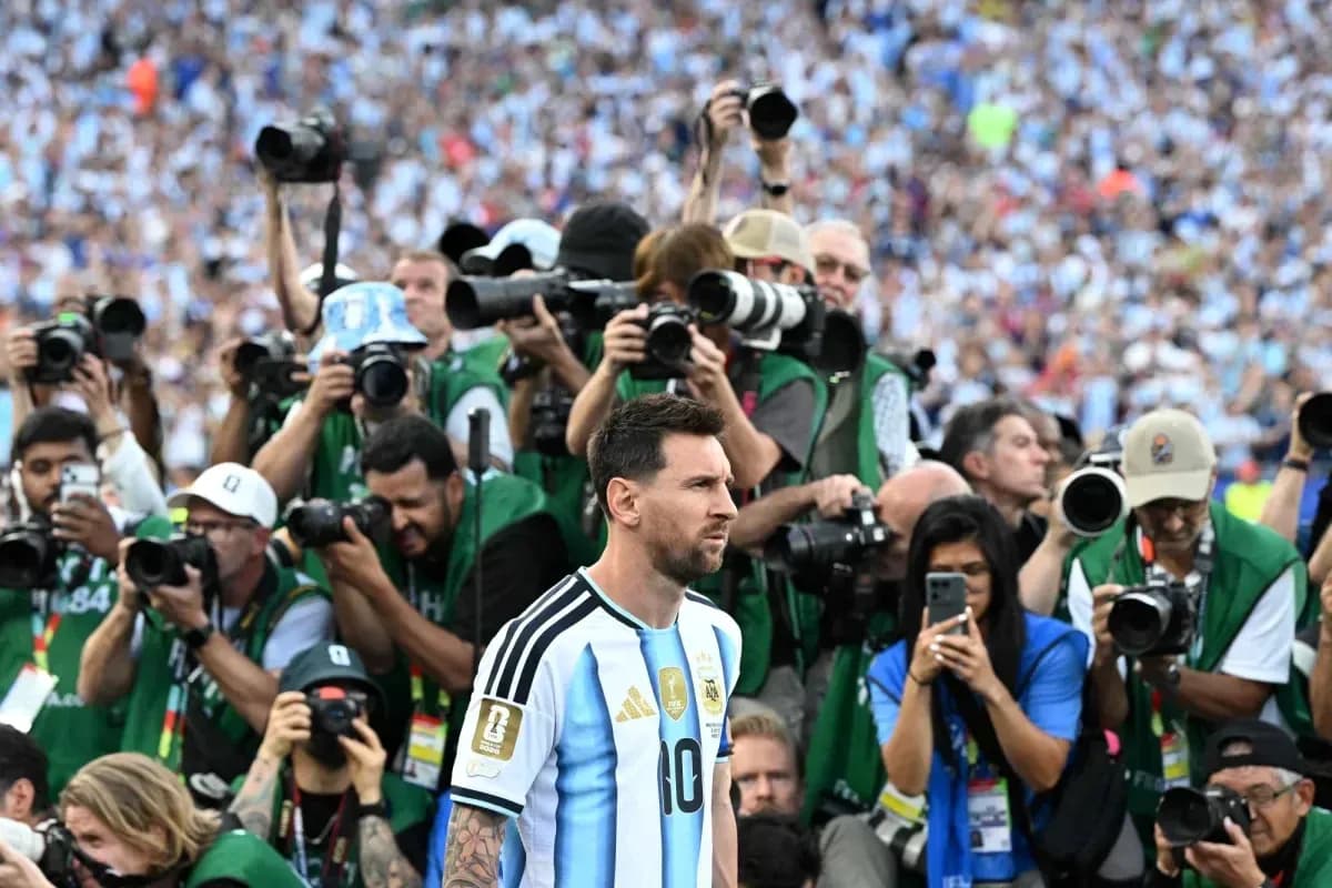 Lionel Messi surrounded by photographers after match