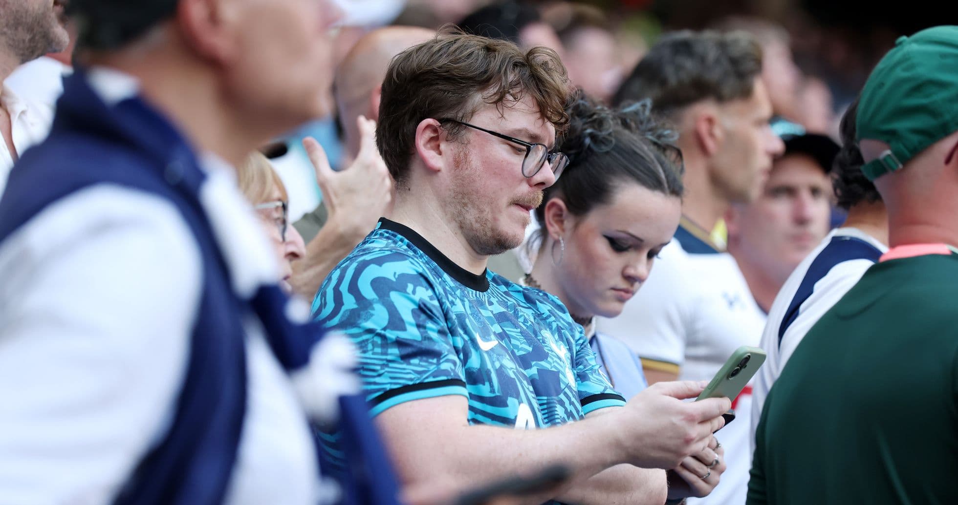 A group of fans watching a match in the stands