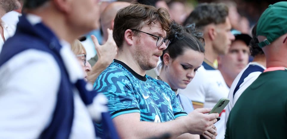 A group of fans watching a match in the stands