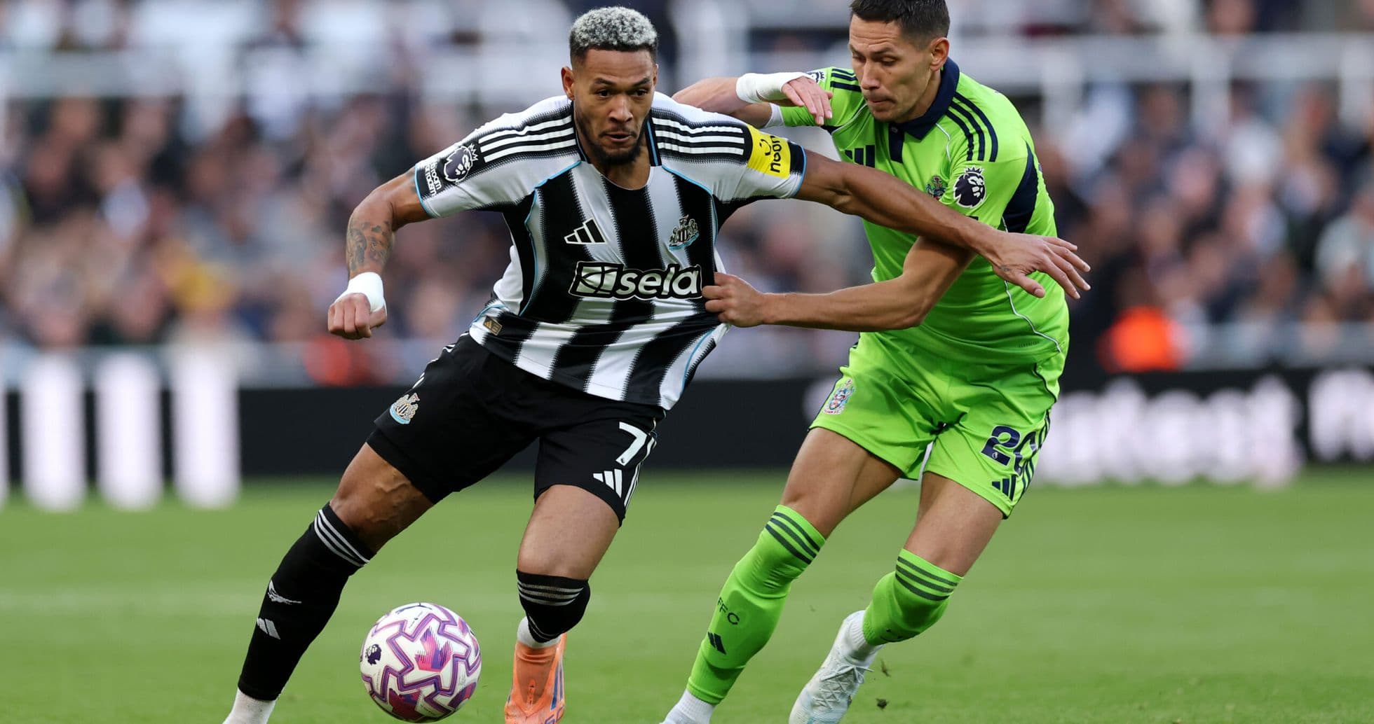 Jugador de Newcastle compitiendo por el balón Jugador de Newcastle compitiendo por el balón